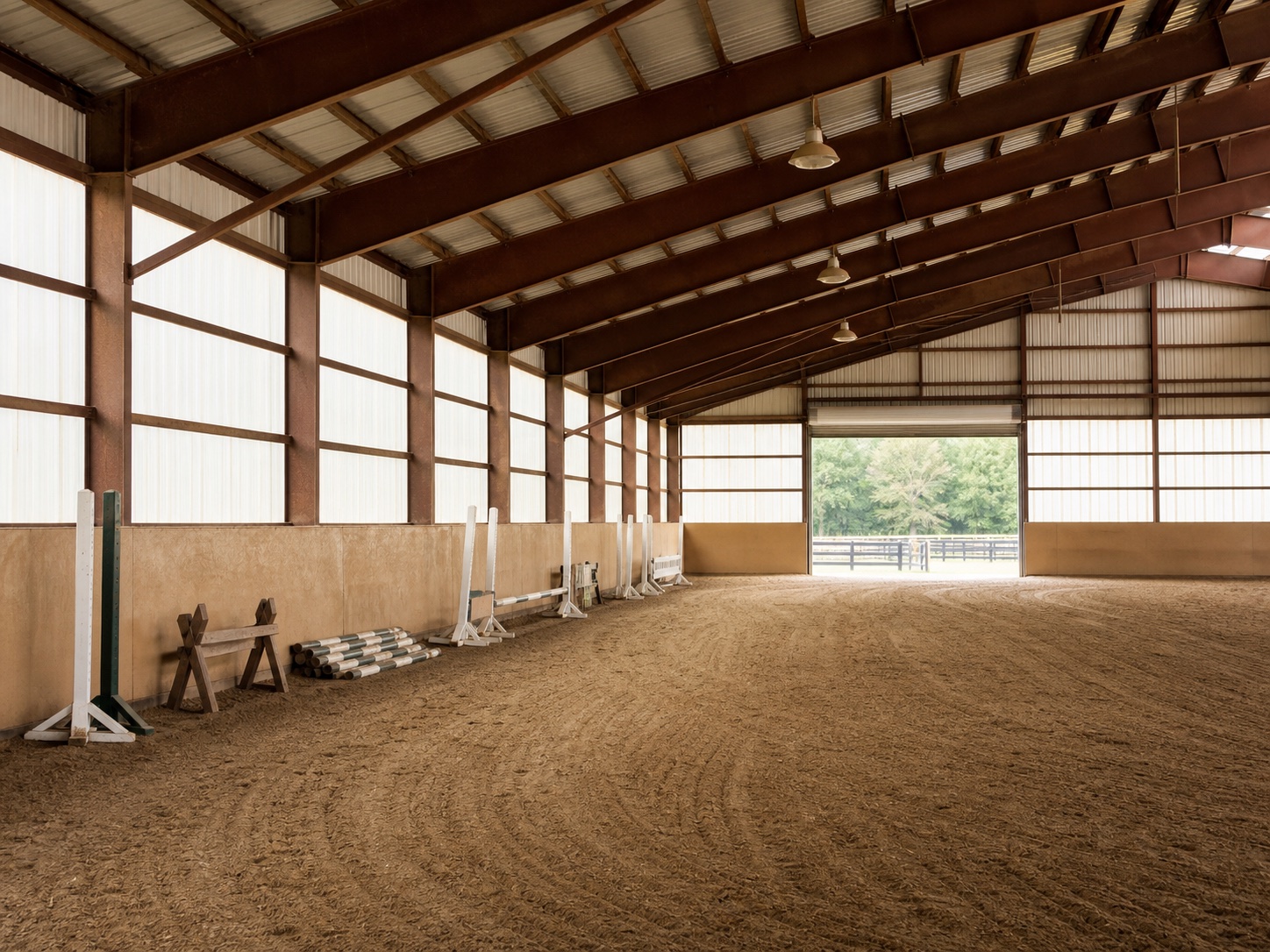 Illustrative view of an indoor riding ring at a working horse farm