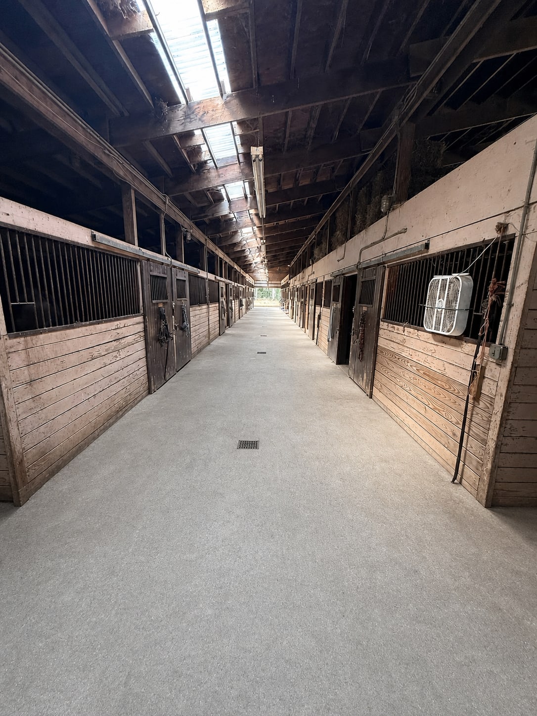 Main barn aisle and stall fronts at River Vu Farms